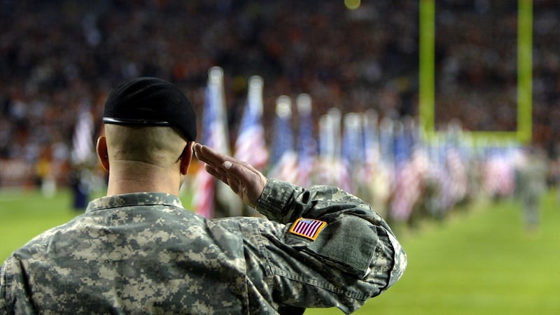 A member of the US Armed Forces salutes during pregame ceremonies beforeNew England Patriots’ meeting with the Denver Broncos. Photo: Doug Pensinger/Getty Images