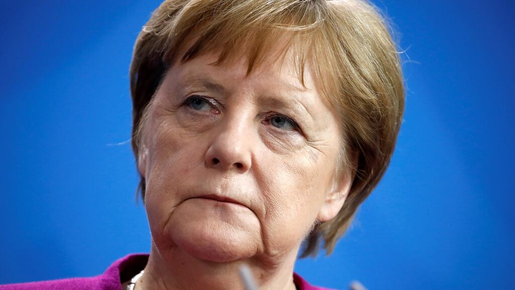German chancellor Angela Merkel listens during a press conference.