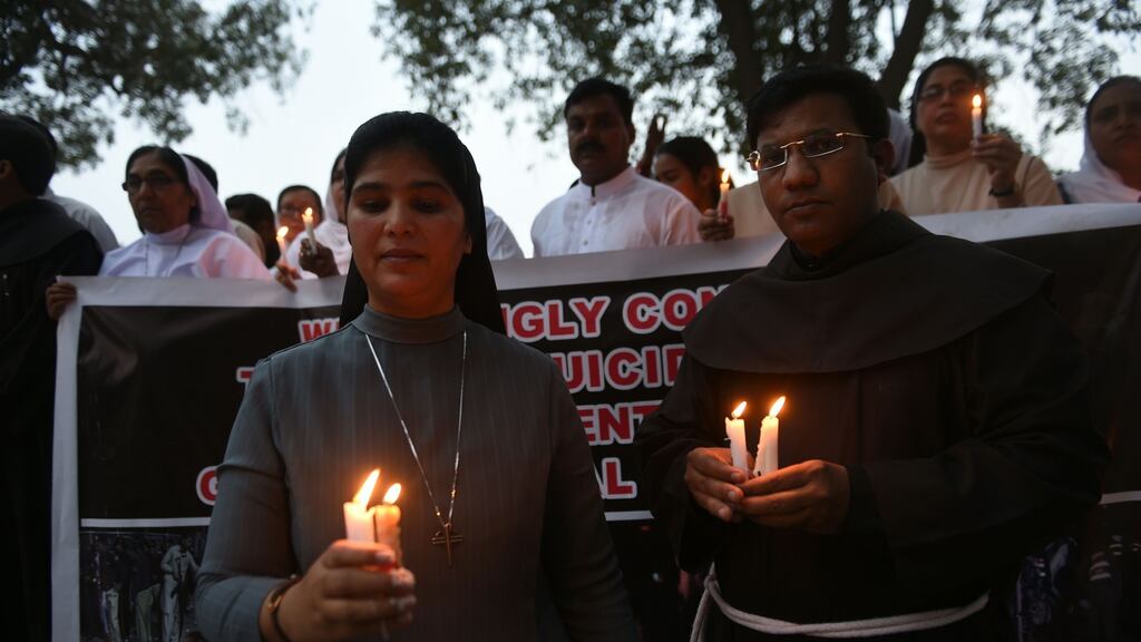 Pakistani Christians hold candles for victims of suicide-blast by new Islamic extremist faction. Photograph: Farooq Naeem/AFP/Getty Images