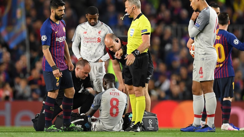 Naby Keita of Liverpool is seen to by medical staff after he got injured during the Uefa Champions League semi-final first leg against Barcelona. Photo: Matthias Hangst/Getty Images