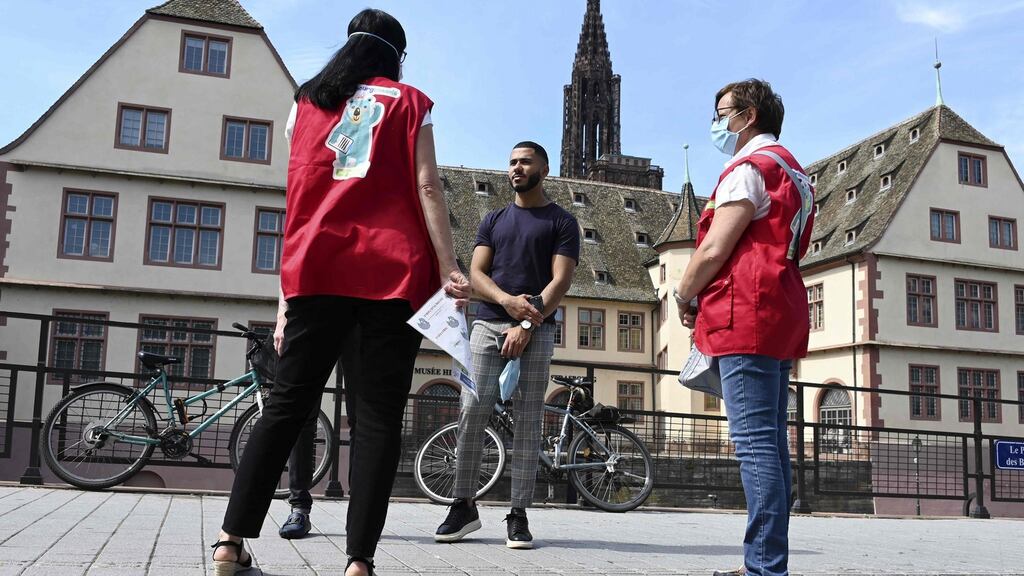 Mediators from the Strasbourg City Hall talk to people in the street about the prevention of coronavirus. Photo: Frederick Florin/AFP via Getty Images
