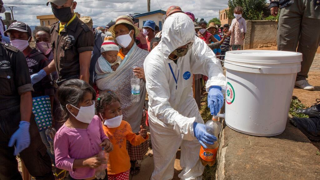 Residents in Antanarivo, Madagascar, are given bottles of an untested herbal mixture said to prevent and cure Covid-19. Photograph: Alexander Joe
