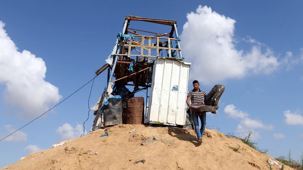A Palestinian man removes a chair at a Hamas observation post that was targeted in Israeli shelling. Photograph: Reuters