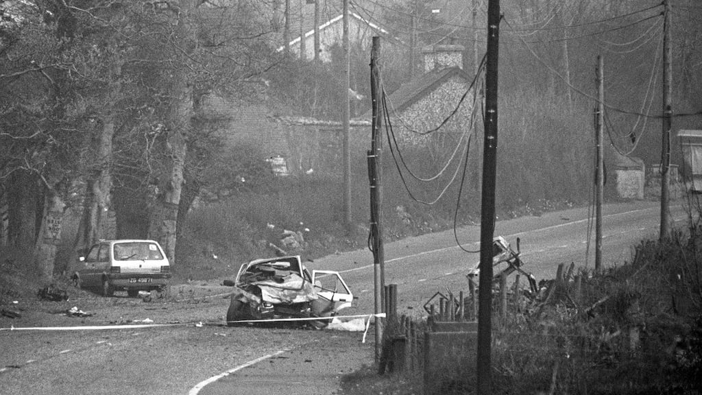 The scene of the IRA car bomb at Killeen in April 1987 in which Judge Maurice Gibson and his wife Lady Cecily Gibson were killed. What remained of their car is to the right behind the telegraph poles. The car in which |reland internationals David Irwin, Nigel Carr and Philip Rainey were travelling is in the middle of the road.
