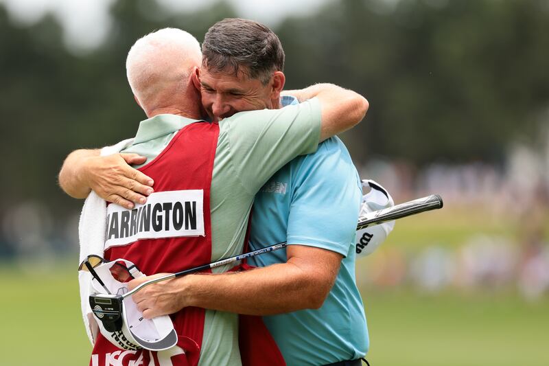 Pádraig Harrington celebrates with caddie Ronan Flood after winning the US Senior Open on Sunday. Photograph: Andrew Wevers/Getty Images