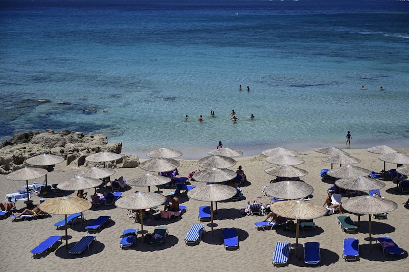 Tourists on Phalasarna beach, northwest of the Greek Mediterranean island of Crete. Photograph: Louisa Gouliamaki/Getty Images