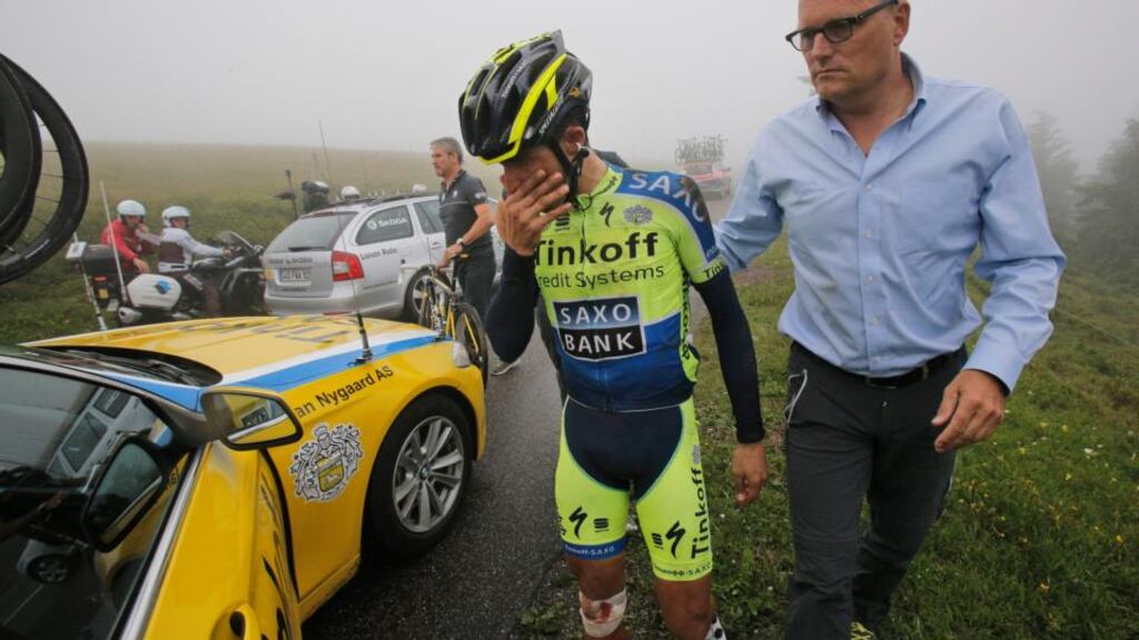 Spain’s Alberto Contador, acompanied by his Saxo-Tinkof team manager Bjarne Riis, abandons the Tour de France after crashing during the 10th stage, which started in Mulhouse and finished in La Planche des Belles Filles. Photograph: Christophe Ena/AP