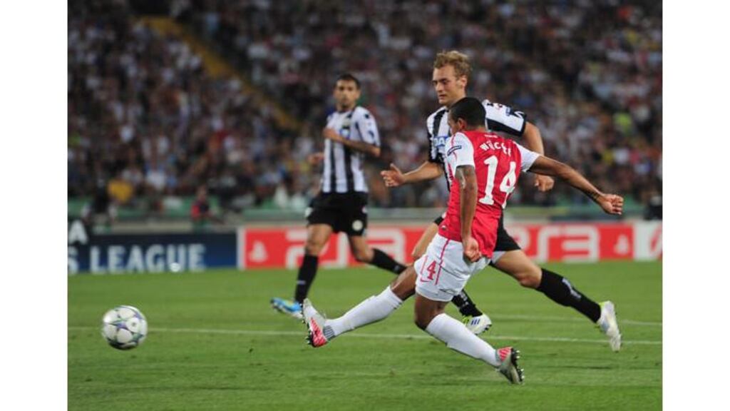 Theo Walcott scores Arsenal’s second goal against Udinese as the Gunners advanced to the Champions League group stages. Photograph: Jamie McDonald/Getty Images