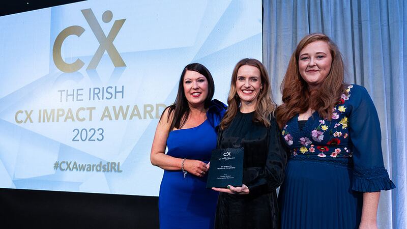 Tara Martin, awards judge, presents the CX impact in tourism & hospitality award to Gemma Sexton and Gemma Howe, Trinity Brand Commercial Services.