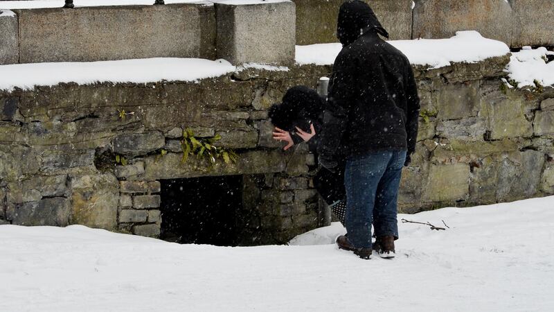 Members of the Safetynet / Simon Community attempt to coax a homeless person living in a hole in a wall near a waterway in Dublin to accept an offer of accommodation on Thursday. Photograph: Alan Betson/The Irish Times