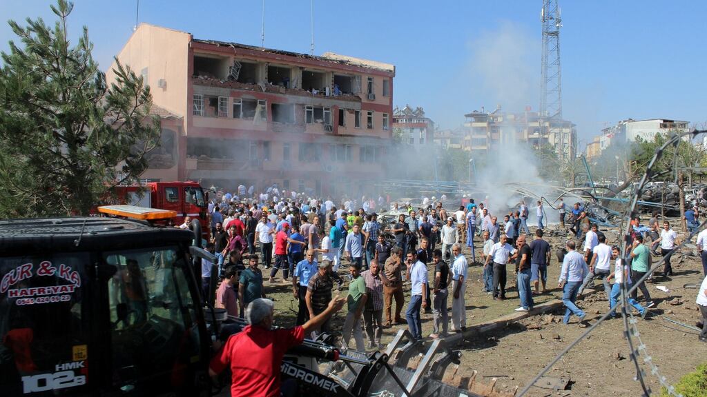 People rush to the blast scene after a car bomb attack on a police station in the eastern Turkish city of Elazig on Thursday. Photograph: Kamilcan Kilic/Ihlas News Agency via Reuters