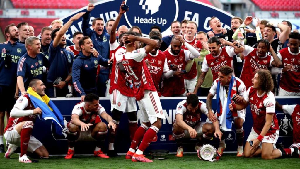 Arsenal players react after Pierre-Emerick Aubameyang drops the trophy. Photograph: PA