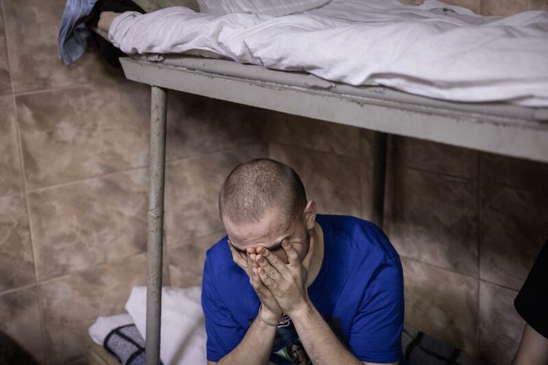 A Russian prisoner of war hides his face in a Ukrainian prison cell in northern Ukraine on Friday, August 16th, 2024. Photograph: David Guttenfelder/The New York Times