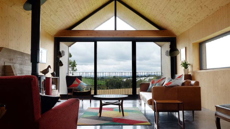 The full-height living room window looks towards the Mourne mountains.
