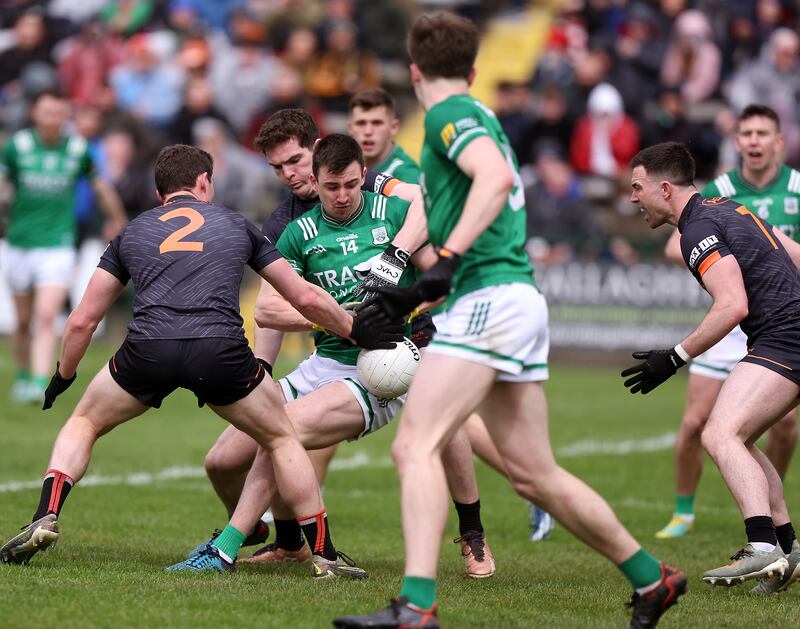 Fermanagh's Garvan Jones is challenged by Armagh's Paddy Burns at Brewster Park. Photograph: John McVitty/Inpho