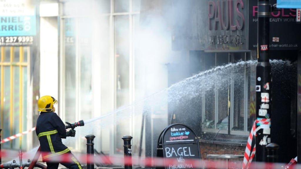 Firefighters at the scene of a fire at Paul’s Hair World in Oldham Street, Manchester, where firefighter Stephen Hunt was killed whilst tackling the blaze. Photograph: Martin Rickett/PA Wire.