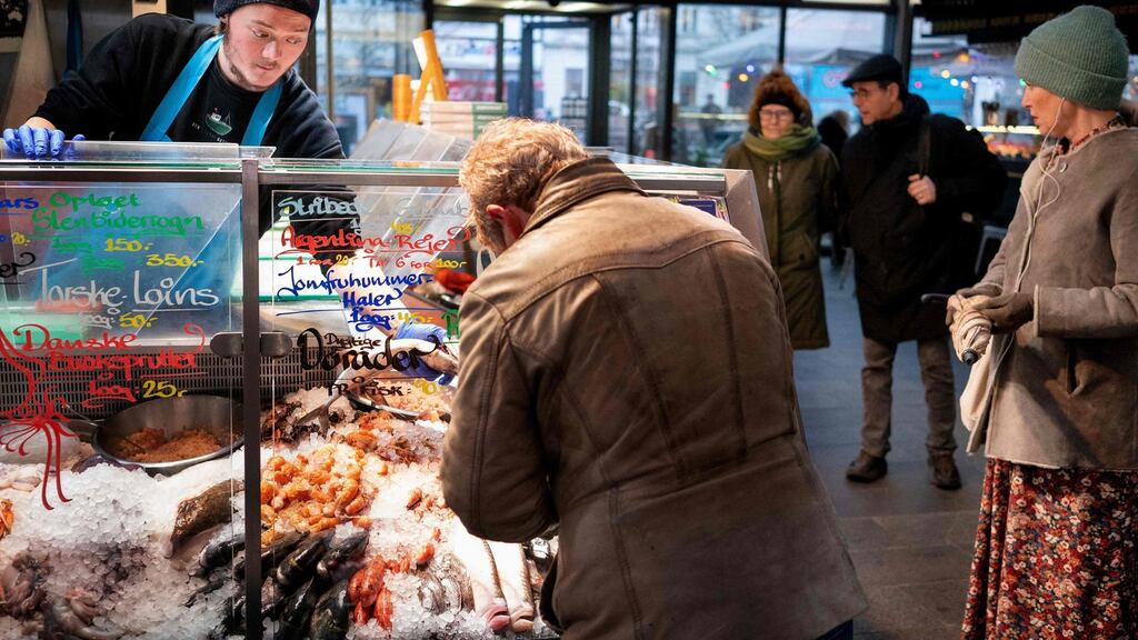 Customers at the fishmarket in Torvehallerne in Copenhagen on Tuesday, as Denmark becomes the first EU country to lift coronavirus restrictions. Photograph: AFP via Getty Images
