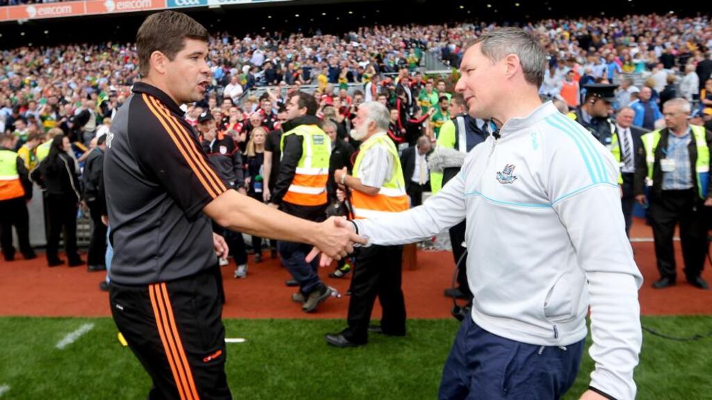 Kerry manager Eamonn Fitzmaurice and  Dublin manager Jim Gavin shake hands at the final whistle. Photo: James Crombie/Inpho