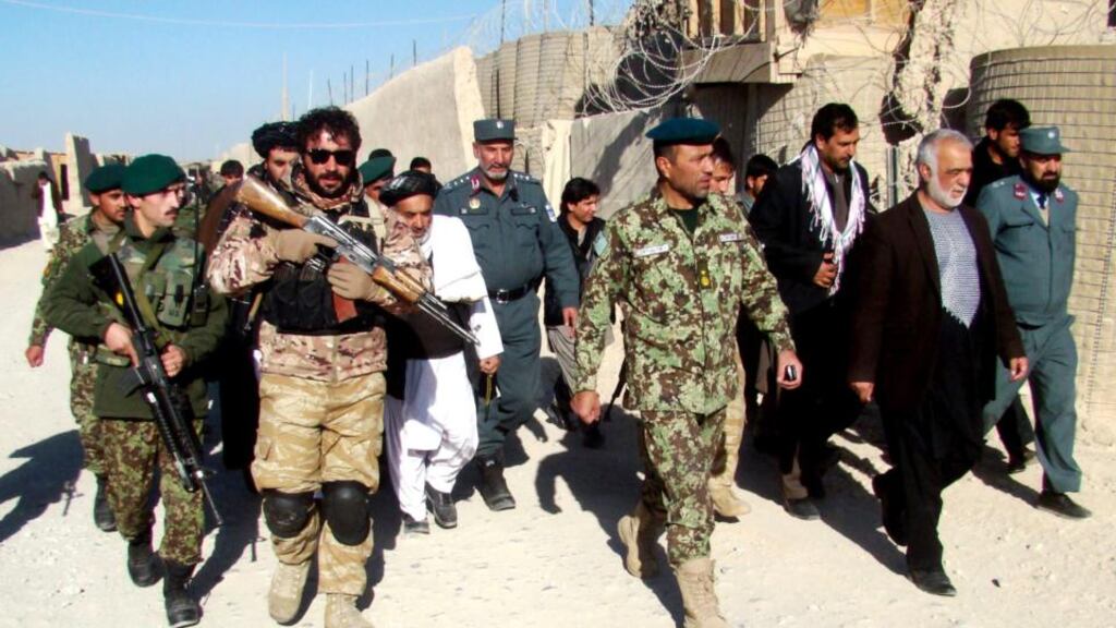 Governor of Helmand Province, Muhammad Naeem Baloch (third from right), visits the location of a rocket attack which hit a house where a wedding was taking place in the Sangin District. Photograph: Watan Yar/EPA
