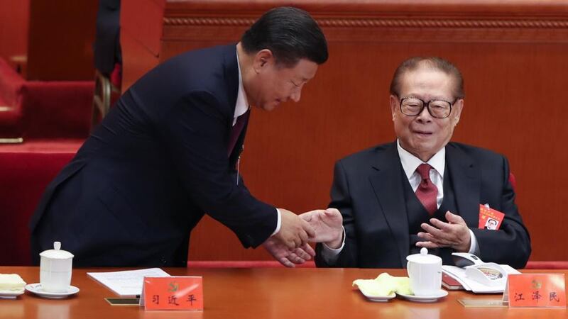 Chinese president Xi Jinping shakes hands with former president Jiang Zemin at the Chinese Communist Party’s congress in 2021. Photograph: Lintao Zhang/Getty Images