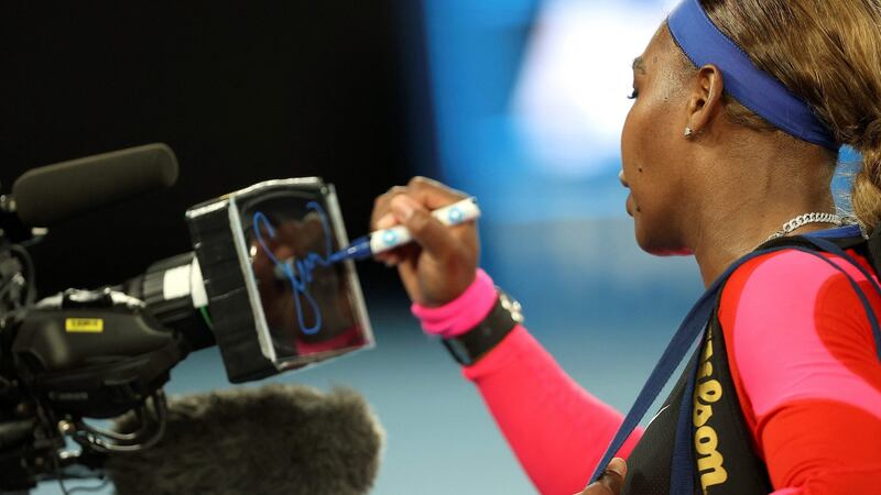 Serena Williams signs a camera after her win over Simona Halep. Photograph: Brandon Malone/Getty/AFP