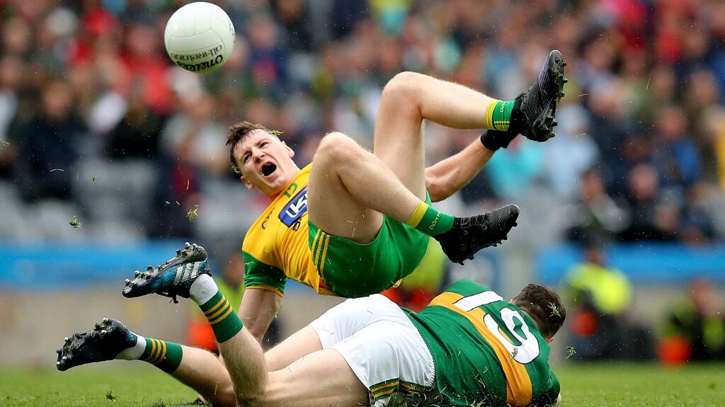 Donegal’s Jamei Brennan and Kerry’s Mark Griffin take a tumble during yesterday’s quarter-final phase two clash at Croke Park. Photograph: Ryan Byrne/Inpho