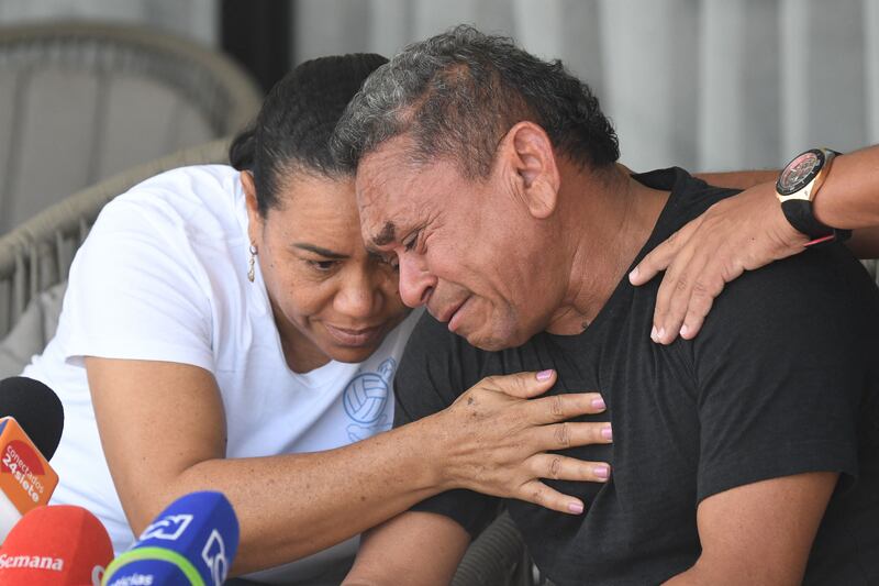 Luis Manuel Diaz, father of Liverpool's forward Luis Diaz, is consoled by his wife Cilenis Marulanda during a press conference at his house in Barrancas, Colombia. Photograph: Daniel Munoz/AFP/Getty