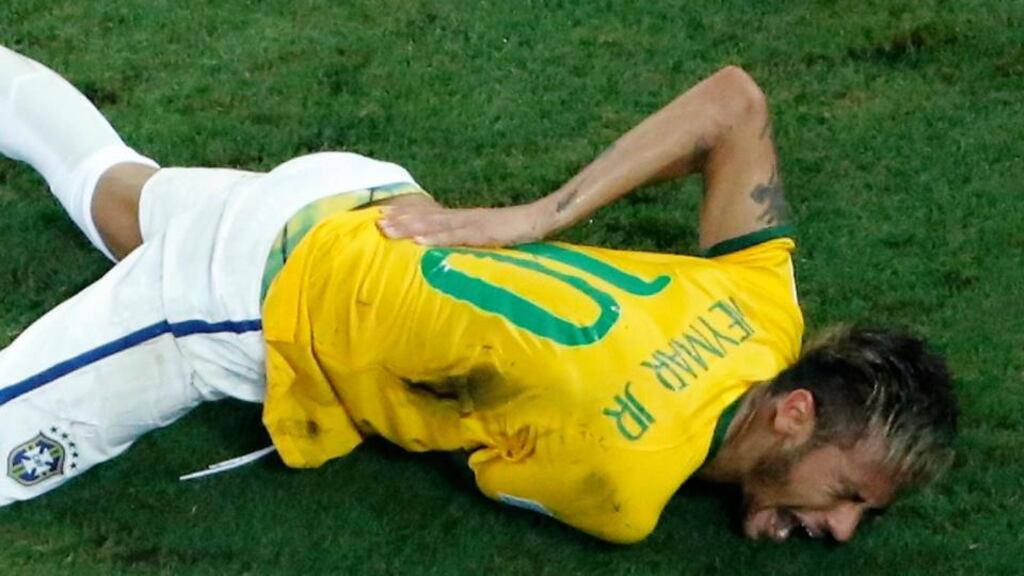 Brazil’s Neymar grimaces after a challenge by Colombia’s Camilo Zuniga during last night’s World Cup quarter-final in Fortaleza. The playmaker has been ruled out of the tournament. Photograph: Fabrizio Bensch/Reuters