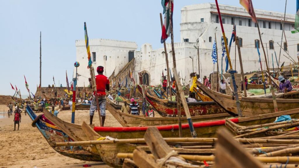 Cape Coast Castle, with its chilling slave dungeons, behind traditional fishing boats. Photographs: Getty