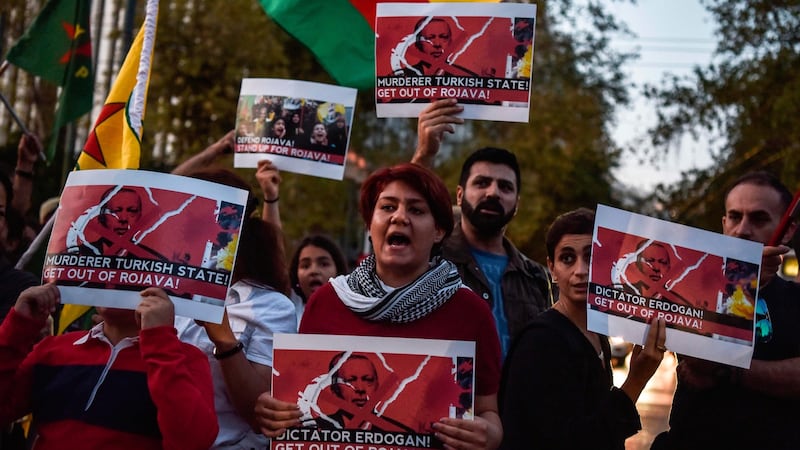 Kurds living in Athens hold banners as they protest near the Turkish embassy in Athens on Wednesday. Photograph: Louisa Gouliamaki/AFP