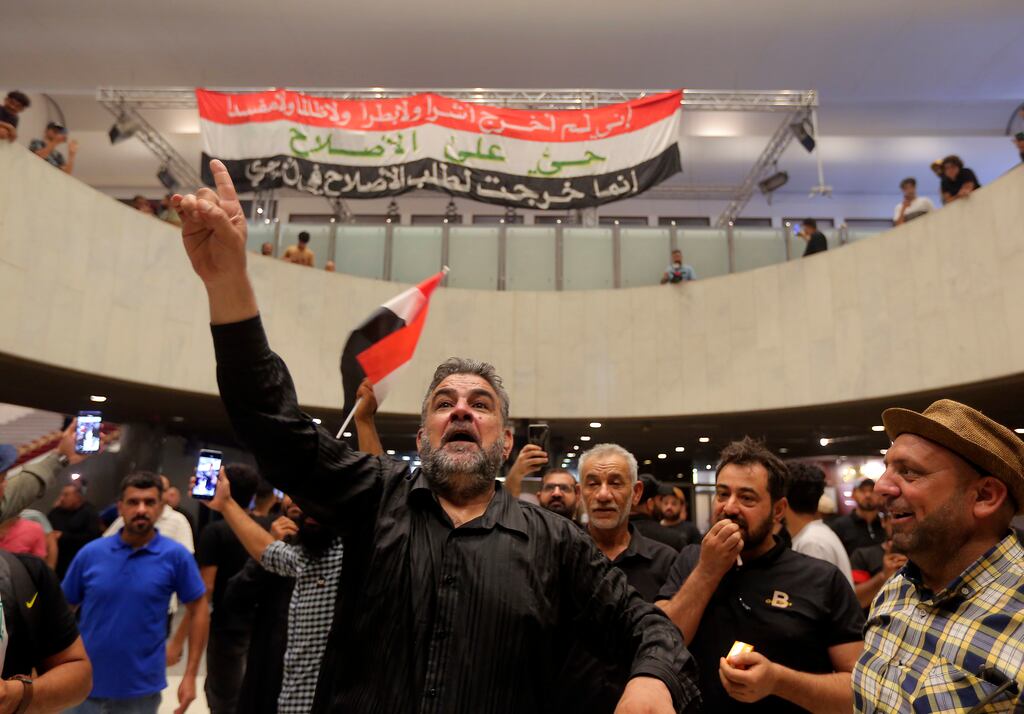 Iraqi protesters inside the parliament building in Baghdad: President Barham Salih has urged the bitterly opposed political blocs to initiate dialogue to 'examine the roots of the crisis' and reach solutions which would 'bring the country to safety and stability'. Photograph: Anmar Khalil/AP