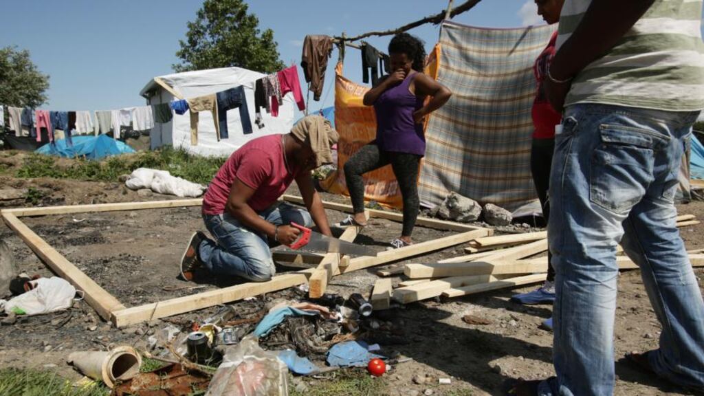 A man building a shelter in the migrant camp in Calais, France. Photograph: Yui Mok/PA Wire