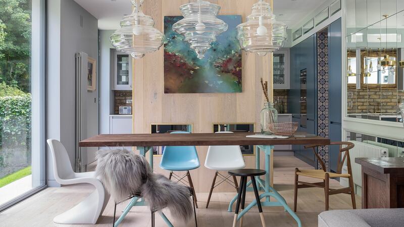 The floor in the diningroom of Roisin Lafferty's reimagined house climbs up the partition half wall to better frame that space