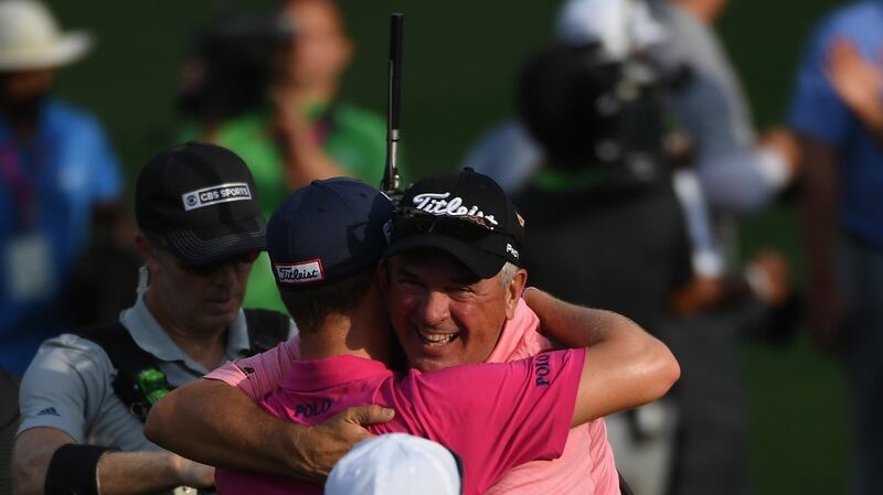 Thomas embraces his father Mike after the final round. Photo: Ross Kinnaird/Getty Images