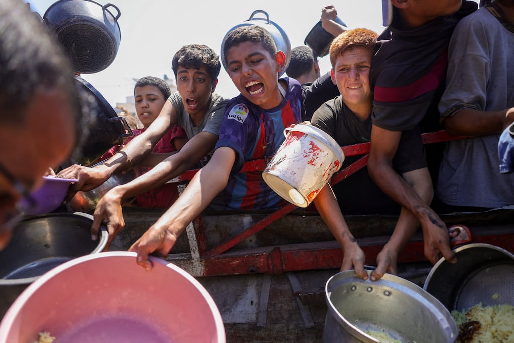 People try to get rice from a charity kitchen providing food for free in the west of Gaza City, on August 28th. Photograph: Bashar Taleb/AFP
