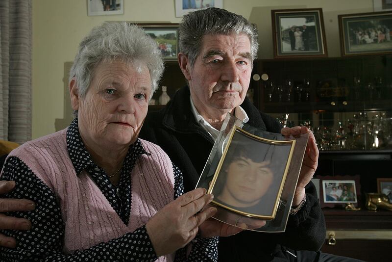 Michael and Peg Ffrench with a photograph of their son Michael in 2006, 25 years after the fire. Photograph: Brenda Fitzsimons