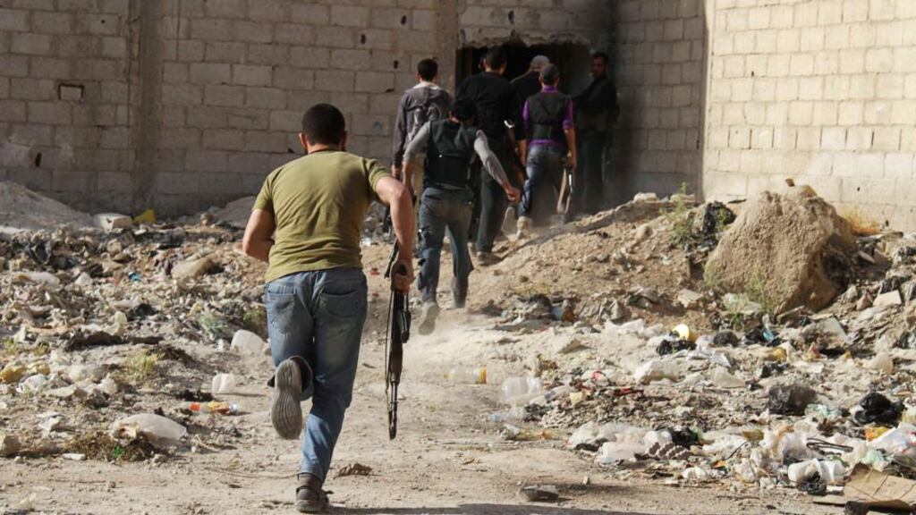 Free Syrian Army fighters carry their weapons as their move towards their positions in the al-Ziyabiya area in Damascus earlier this month. Photograph: Ward Al-Keswani/Reuters