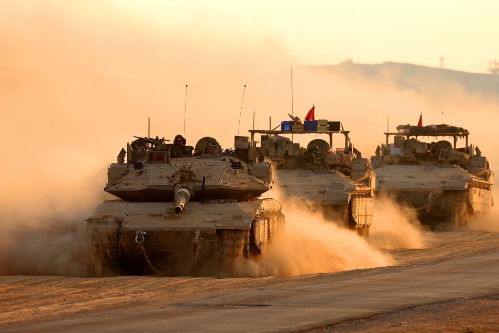 A convoy of Israeli army vehicles moves along the border fence with the Gaza Strip in southern Israel on Friday. Photograph: Jack Guez/AFP via Getty Images