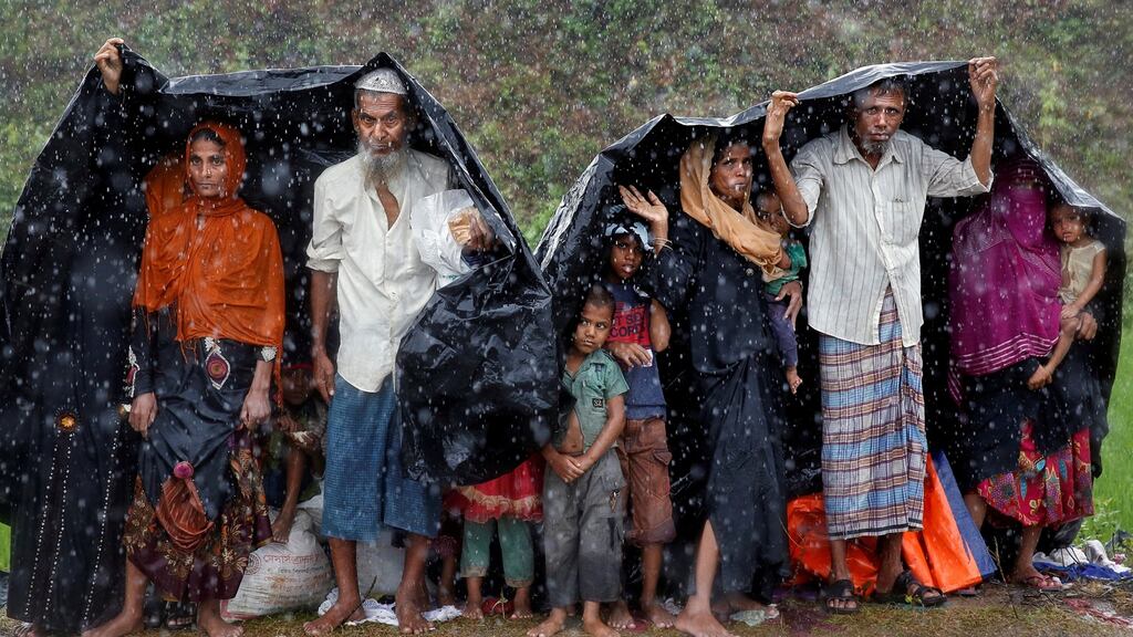 Rohingya refugees shelter from the rain in a camp in Cox’s Bazar, Bangladesh. Photograph: Reuters/Cathal McNaughton