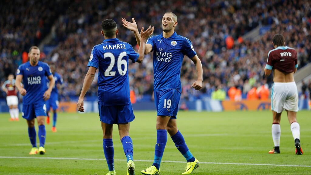 Leicester City’s Riyad Mahrez and Islam Slimani celebrate after Burnley’s Ben Mee scores an own goal to put Leicester 3-0 up in their Premier League clash. Photo: Darren Staples/Reuters