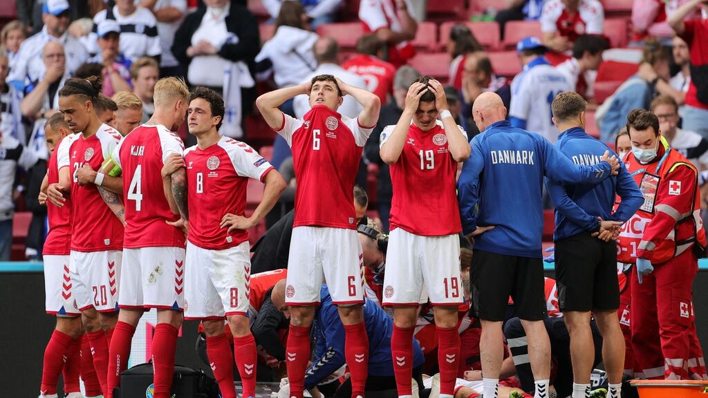 Denmark’s players react as paramedics attend to Christian Eriksen after he collapsed on the pitch during the Uefa EURO 2020 Group B match against Finland at the Parken Stadium in Copenhagen. Photo: Friedemann Vogel/POOL/AFP via Getty Images