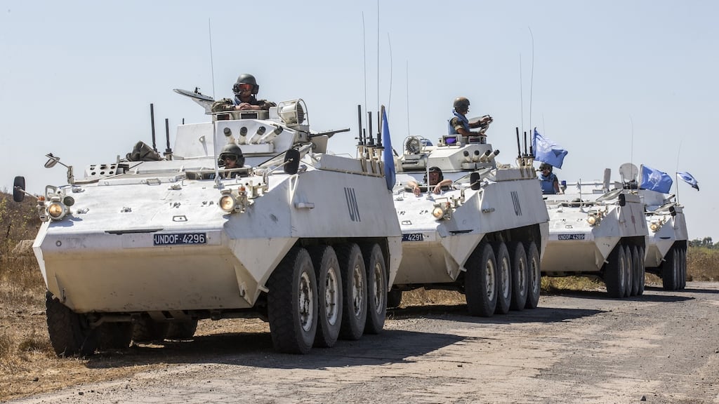 Irish members of UNDOF wait to cross into Syrian-controlled territory from the Golan Heights in 2014. File photograph: Jack Guez/AFP/Getty Images