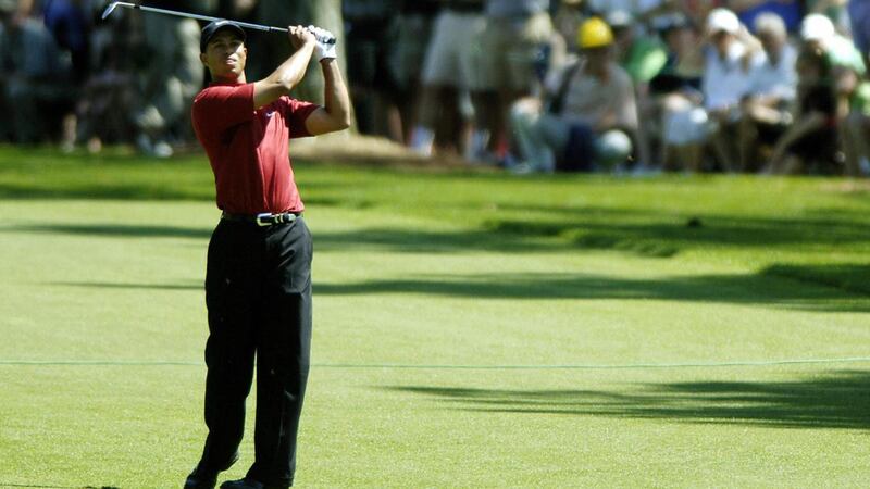 Tiger Woods plays his approach shot to the first green at the start of the final round of the 2005 Masters. Photograph: Roberto  Schmidt/Getty/AFP