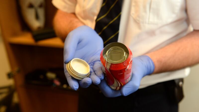 Customs officer Pat Lyons with sample of a mineral tin used to smuggle drugs in Dublin Airport. Photograph: Dara Mac Dónaill / The Irish Times