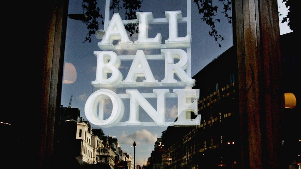 The All Bar One company logo hangs in the window of the bar near Fleet Street in London . Photographer: Carlos Jasso/Bloomberg News