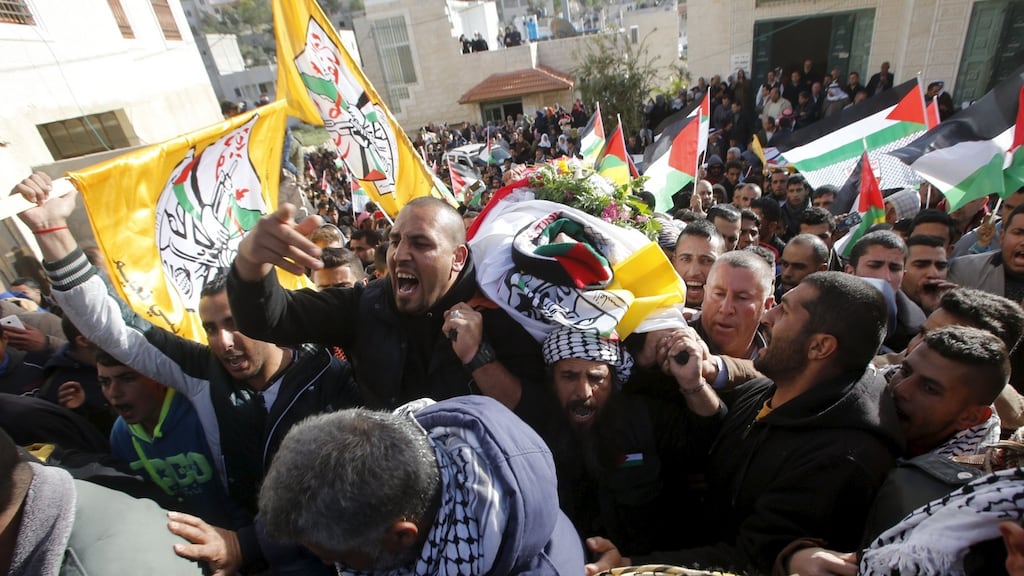 Mourners carry the body of Palestinian Yousef Tarayra, 18, during his funeral in the West Bank. The Israeli military said he was shot dead by the Israeli army after he carried out an attack. Photograph: Mussa Qawasma./Reuters