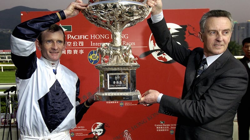 Kevin Manning and Jim Bolger with the trophy after Alexander Goldrun’s win in the Hong Kong Cup at Sha Tin racetrack in December 2004. Photograph: Philippe Lopez/AFP via Getty Images