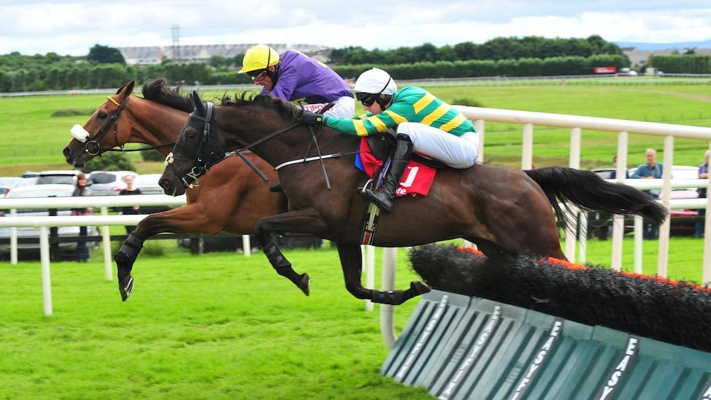 All the Answers ridden by Mark Walsh (right) before winning the Tote Maiden Hurdle ahead of Silver Concorde ridden by Davy Russell (left) during day three of the Galway Festival in Ballybrit. Photo: PA