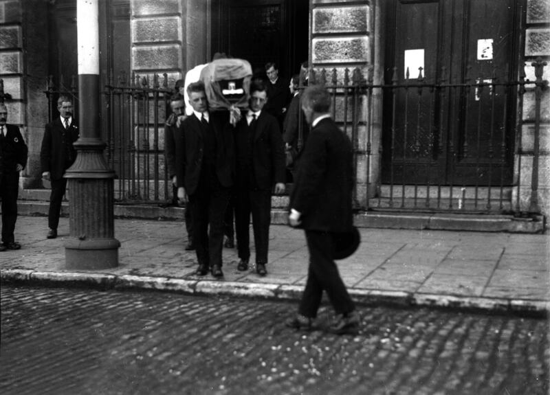 Peter (left) and Sean MacSwiney help carry their brother’s coffin out of City Hall, Cork. Photo Credit: Evening Echo