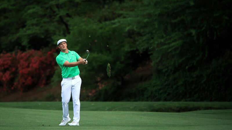DeChambeau plays his approach to the 13th. Photo: Andrew Redington/Getty Images